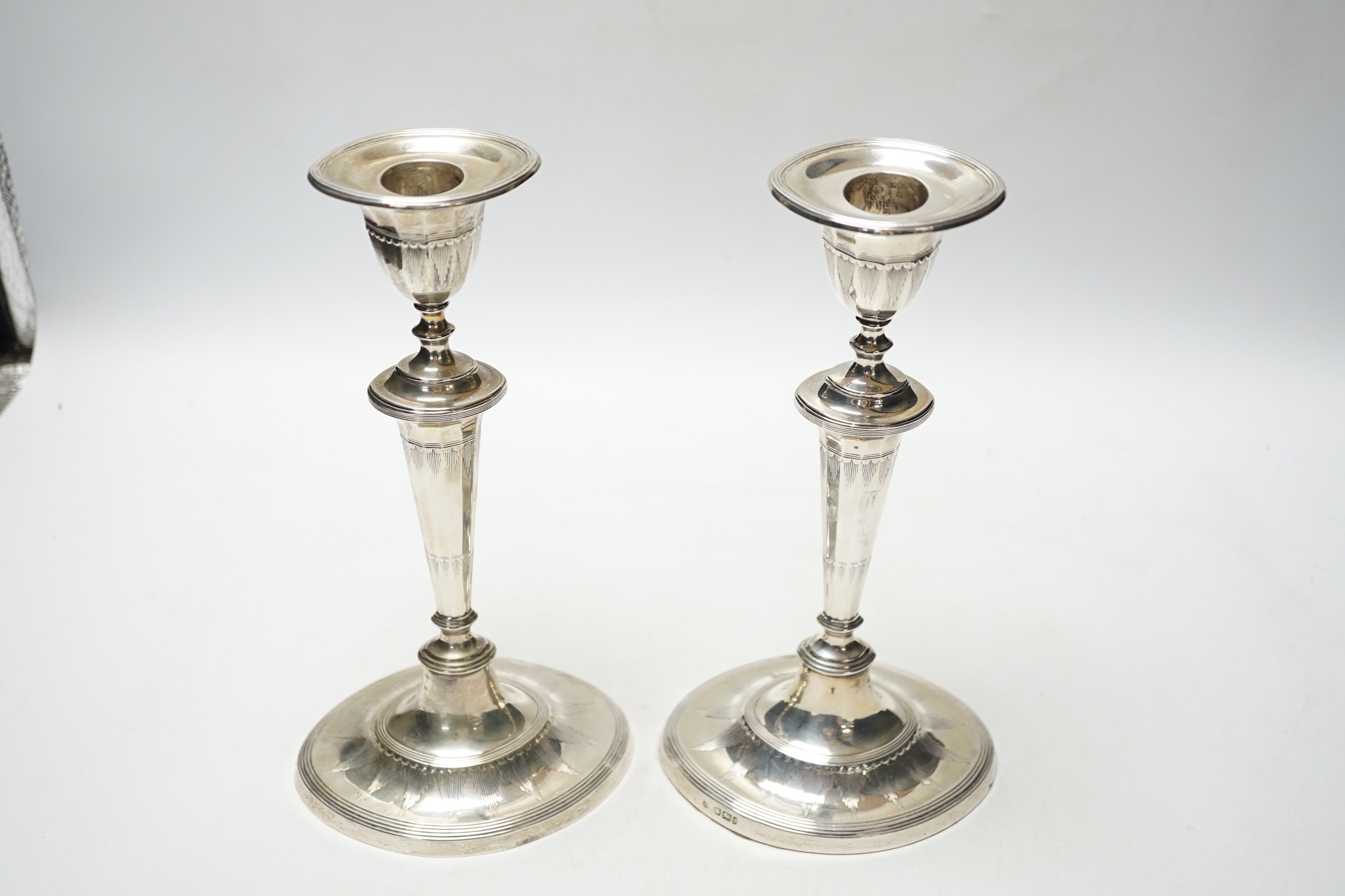 A pair of Edwardian silver mounted oval candlesticks, Thomas Bradbury & Sons, Sheffield, 1901, 23.4cm, weighted.